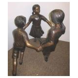 Bronze children playing ring around the rosie.