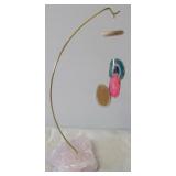 Cut agate mobile on rose quartz base. Measures 9"