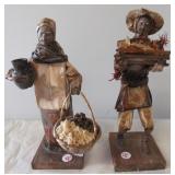 (2) Folk art statues. Measure 11" tall.