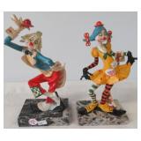 Pair of clown figurines on marble type bases.