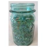Blue glass Ball jar filled with marbles. Jar