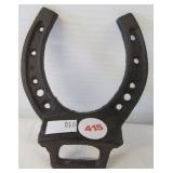 Cast iron horse shoe wall mount bottle opener.