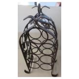 Cast metal wine rack with grape leaf design.