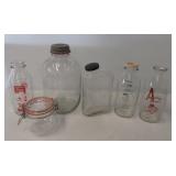 (6) Vintage clear glass bottles including Shelter