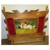 Vintage wood gun rack featuring hunting dog