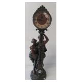 Figural pendulum clock. Measures 27" tall.