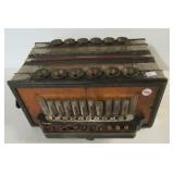 Antique accordion. Measures 6" h x 12.5" w x 10"