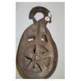 Antique metal barn pulley marked 338ER.
