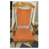 Vintage wood rocking chair with padded seat and