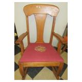 Vintage wood rocking chair with upholstered seat.