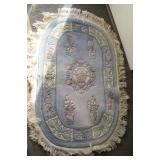 Fringed area rug. Measures 52" x 31.5" without