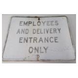 Metal "Employees ad Delivery Entrance Only" sign.
