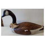 Large wood goose statue. Measures 26" long.