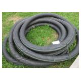 Partial roll of black drain pipe.