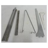 Box full of metal store shelving brackets.