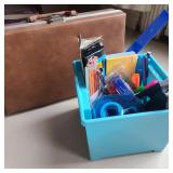 Blue Box of Office Supplies & Tan Mini Suitcase Blue Box of Office Supplies & Tan Mini Suitcase