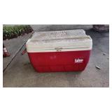 Red and white cooler full of miscellaneous tools. Red and white cooler full of miscellaneous tools.