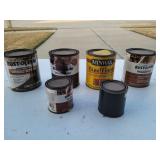 Six partial cans of wood stain and finish
