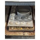 Baking pans, including muffin tins and a round
