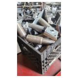 A bin of miscellaneous table legs casters parts