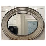 36"x28"Oval mirror with a rustic finished frame.