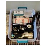 Bin full of various Office supplies including