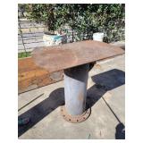 Piece of pipe with metal plate welded on the end.