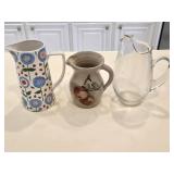(2) Stoneware Pitchers & a Glass Pitcher