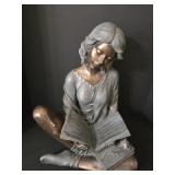 This sculpture is a Bronze-toned Figure of a