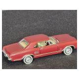 1:43 Burgundy Diecast Model of a 1963 Buick Rivier