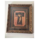 Framed in an ornate, distressed gold molding,