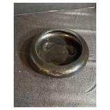 A shallow, round ceramic planter bowl or