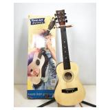 First Act Discovery acoustic guitar on stand