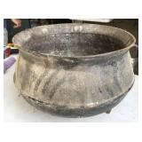 cast iron pot with holes drilled in bottom to