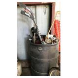 barrel of golf clubs, hockey sticks, golf balls