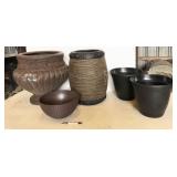 assorted flower pots, some damaged