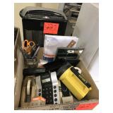 box of office supplies and personal shredder