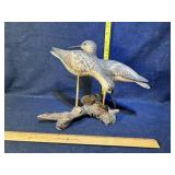 Wooden birds on driftwood
