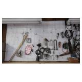 Contents of Wall incl Saw Chains, Mower Blades,