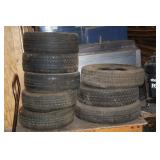 Stack of eight assorted vehicle tires