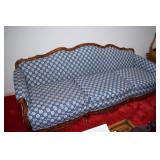 Blue and white couch with wood border