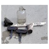 Lot of old turn signals, sign, jug.