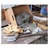 Parts bins with contents, funnels, saw handles.