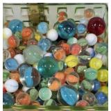 Large square glass jar full of marbles