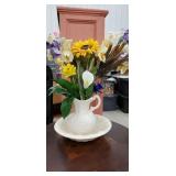 White pitcher and bowl with flowers and food in