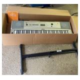 Yamaha keyboard with stand, headphones and course