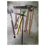 Lot of yard tools. Rakes, broom, shovel etc.