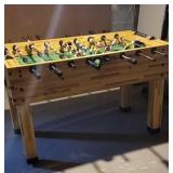 Foosball table in basement being your own help