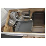 Bottom drawer full of bakeware, pans, etc