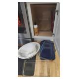 Contents of cupboard to the right of the stove